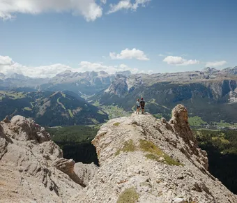 A Couple Enjoying a Stunning Dolomites Valley View. Ph Alex Moling